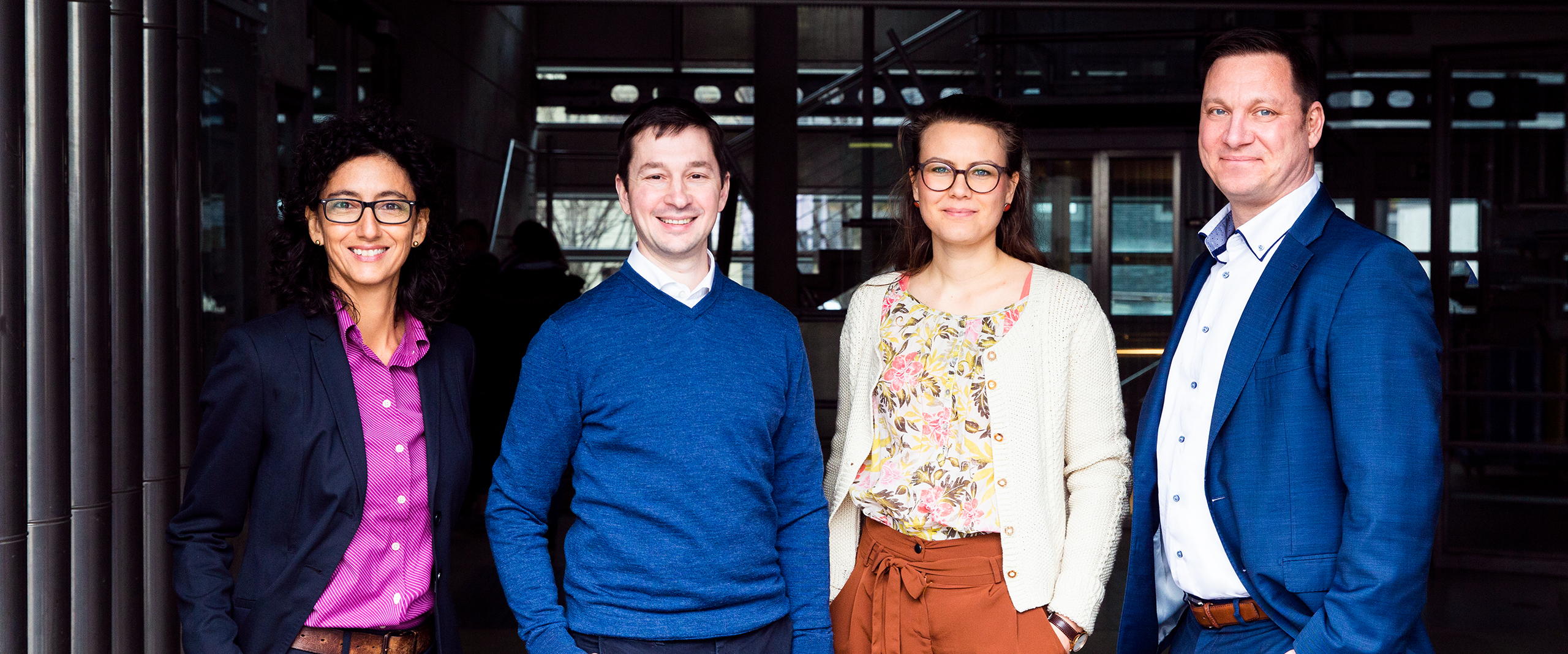 Portrait of the four participants in the table conversation.