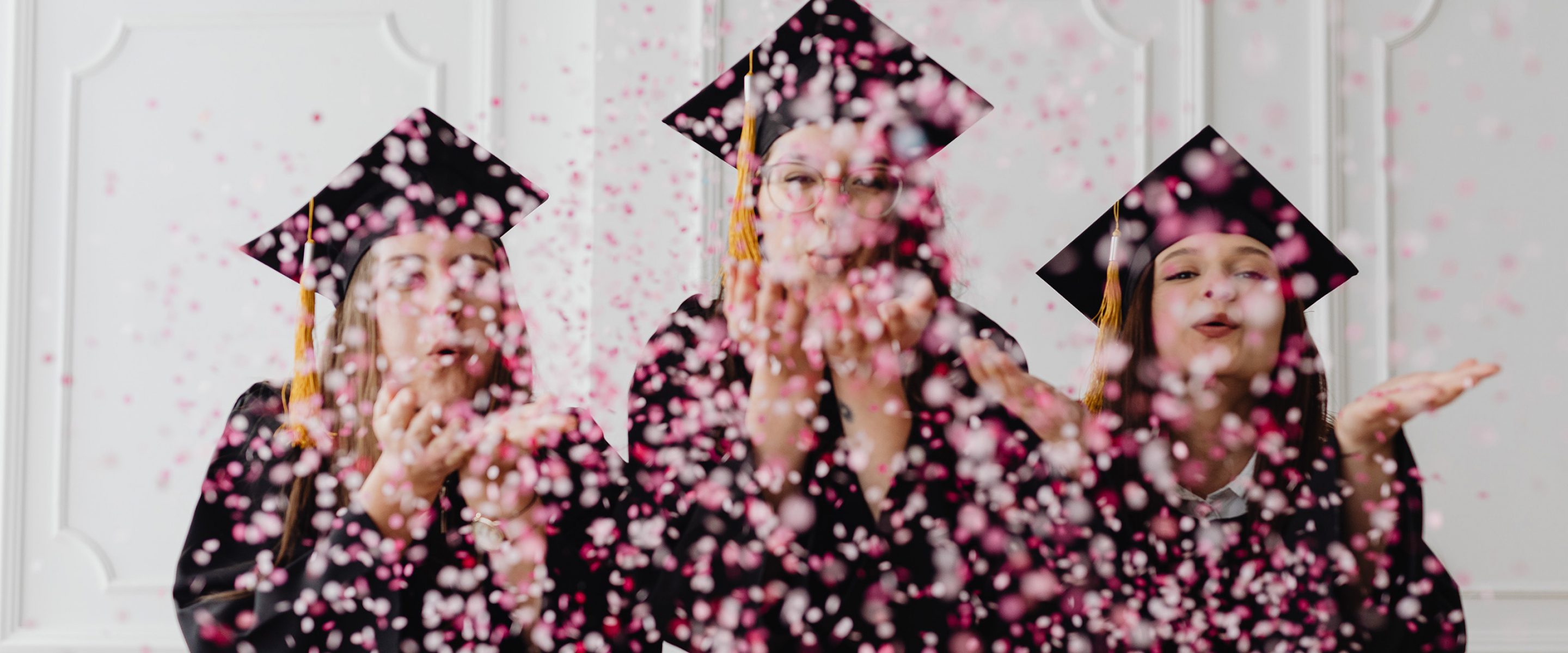 Three women celebrate their graduation.