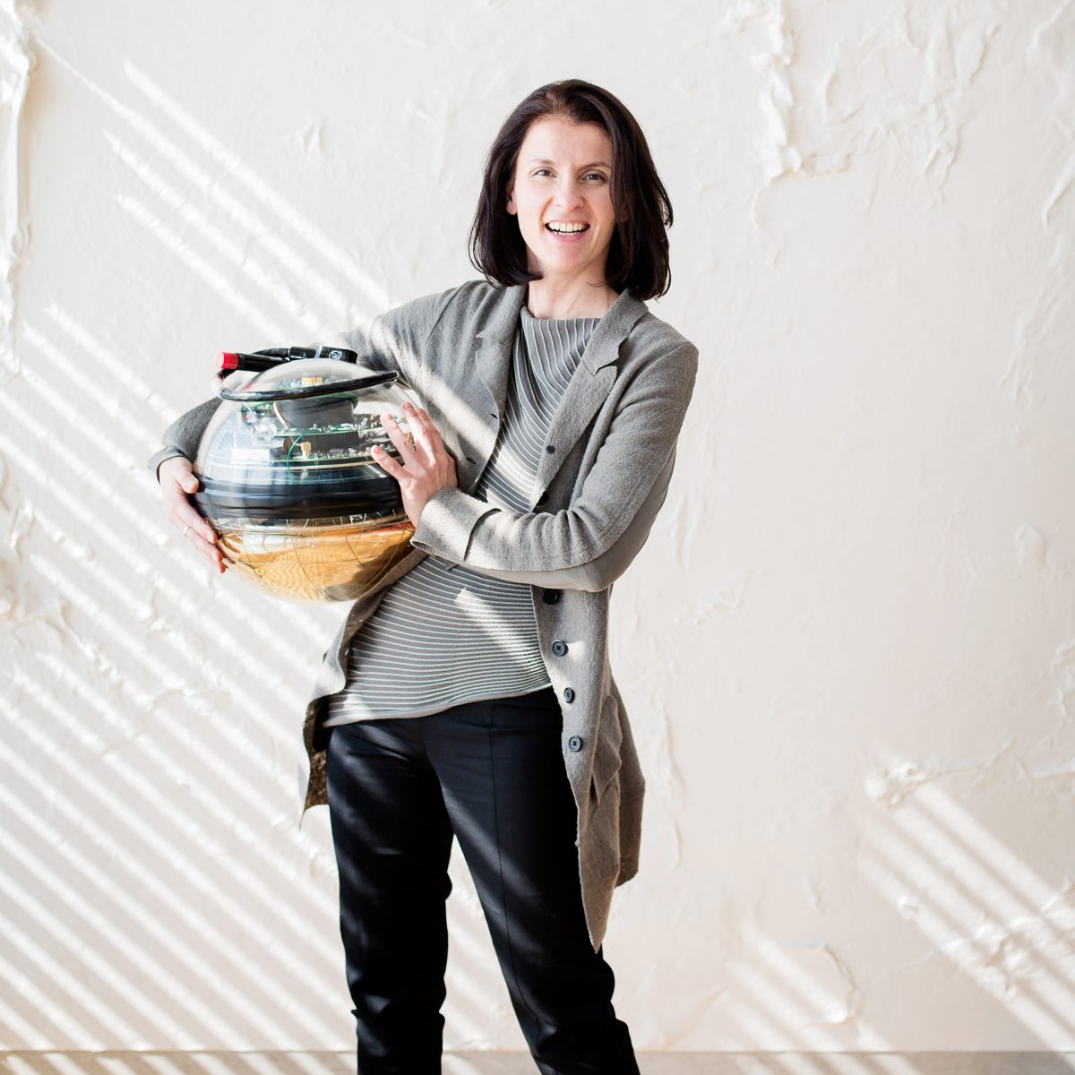 TUM Professor Elisa Resconi with one of the IceCube telescope's glass spheres.