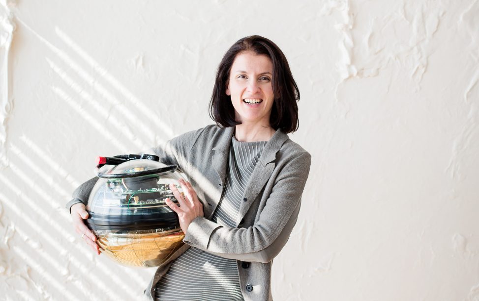 TUM Professor Elisa Resconi with one of the IceCube telescope's glass spheres.