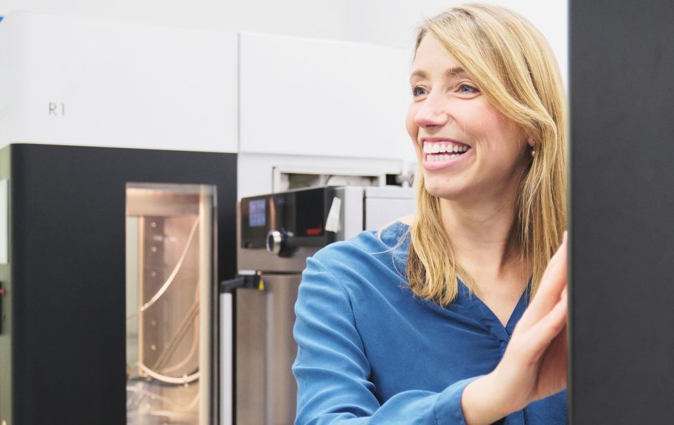 Miriam Haerst in front of the 3D printer she developed.