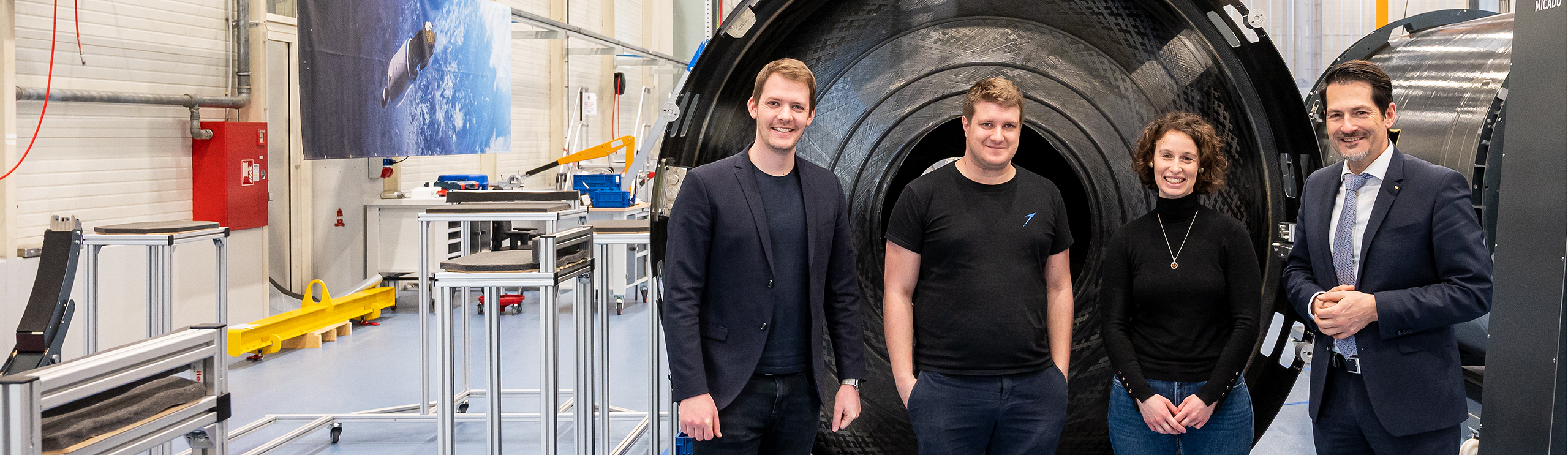 President Thomas F. Hofmann stands in front of a rocket model in Isar Aerospace's production halls.