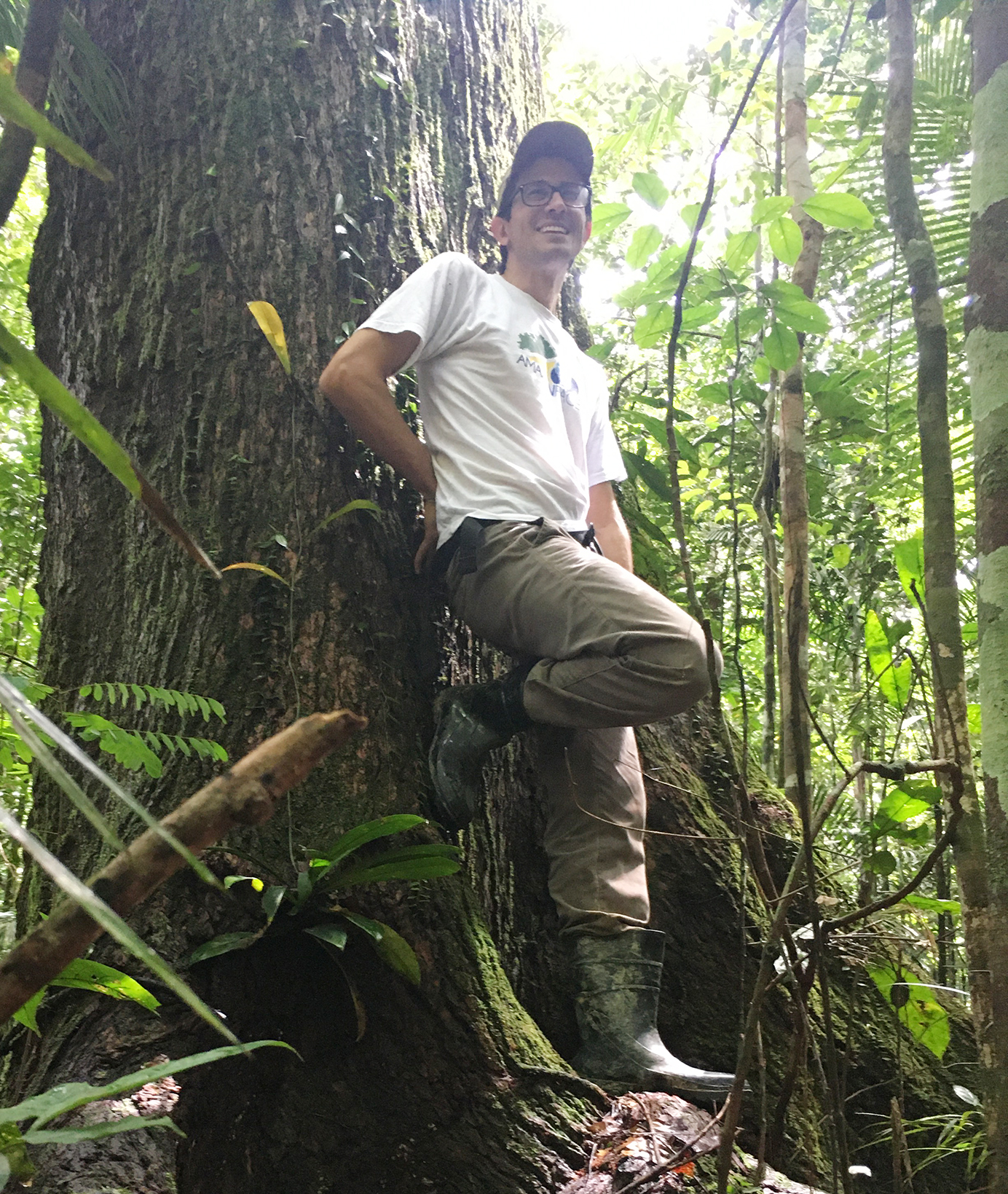 TUM Ambassador David Lapola leans against a tree in the rainforest.