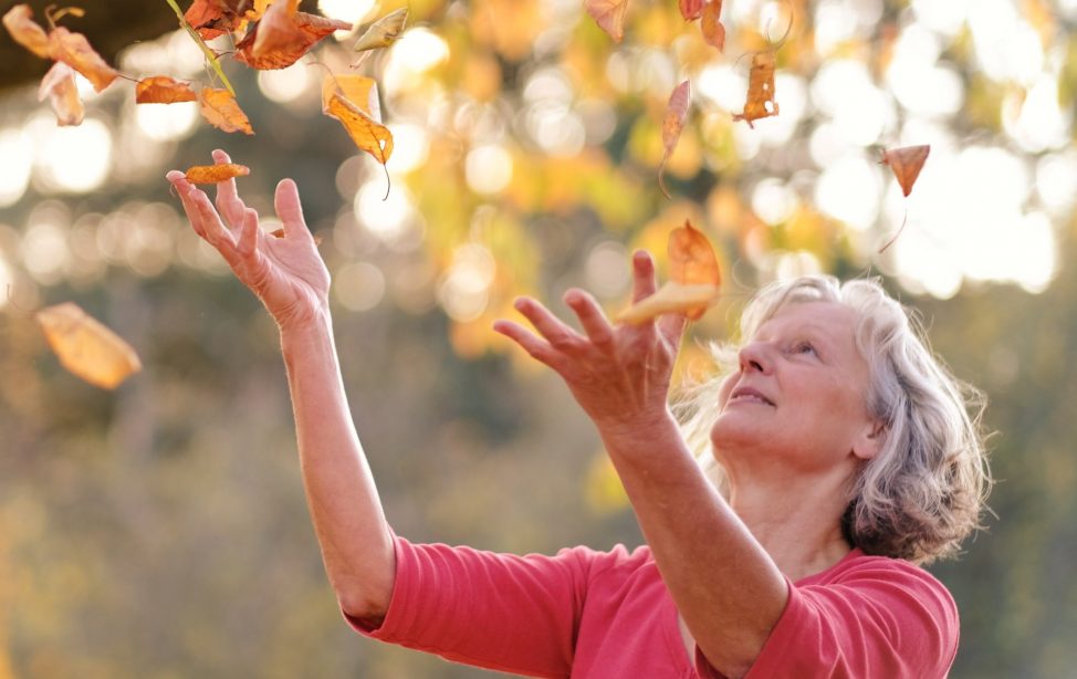 TUM Alumni Freia Jung-Klein with autumn leaves.